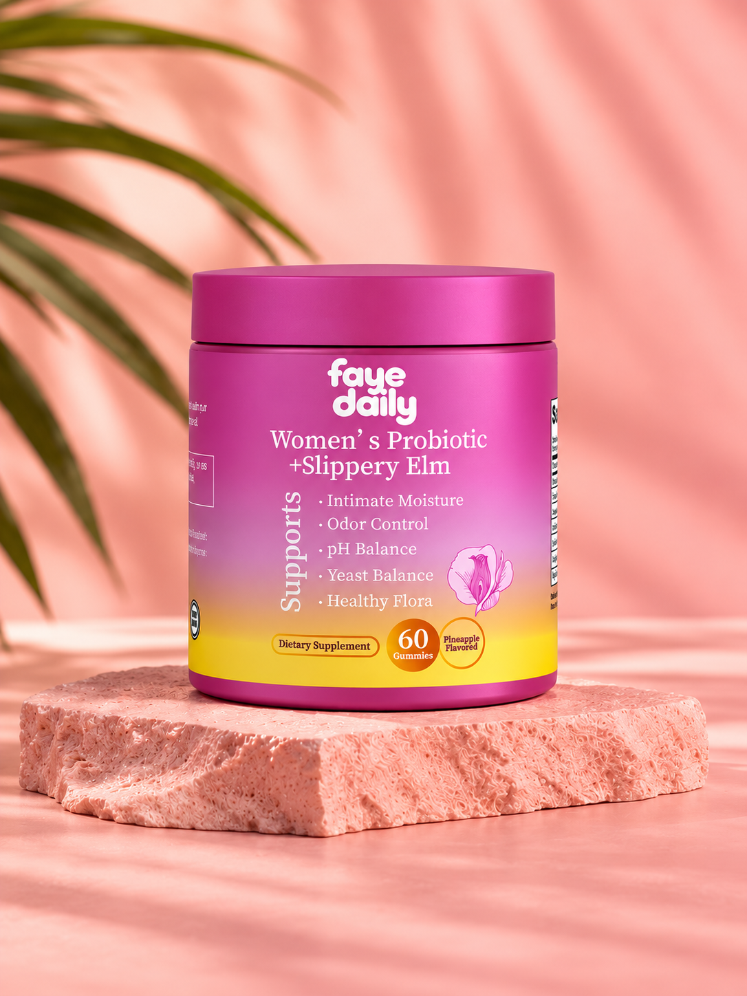 Faye Daily Women's Probiotic + Slippery Elm Gummies jar on a pink stone pedestal